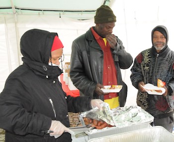 Diane_Latiker_hands_out_food_wearing_mask2_3.jpg